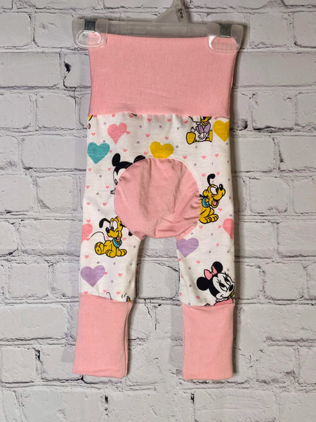 Back: White pants with pink and purple small hearts. Larger hearts of purple, teal and pink mixed in with baby Mickey and Minnie Mouse and Pluto. Soft pink waistband extended and leg bands extended for larger size. Matching soft pink bum circle.